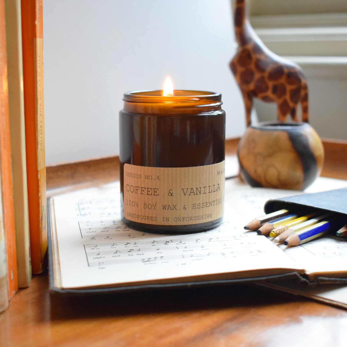 lit open 180ml coffee and vanilla eco soy wax candle with pencils