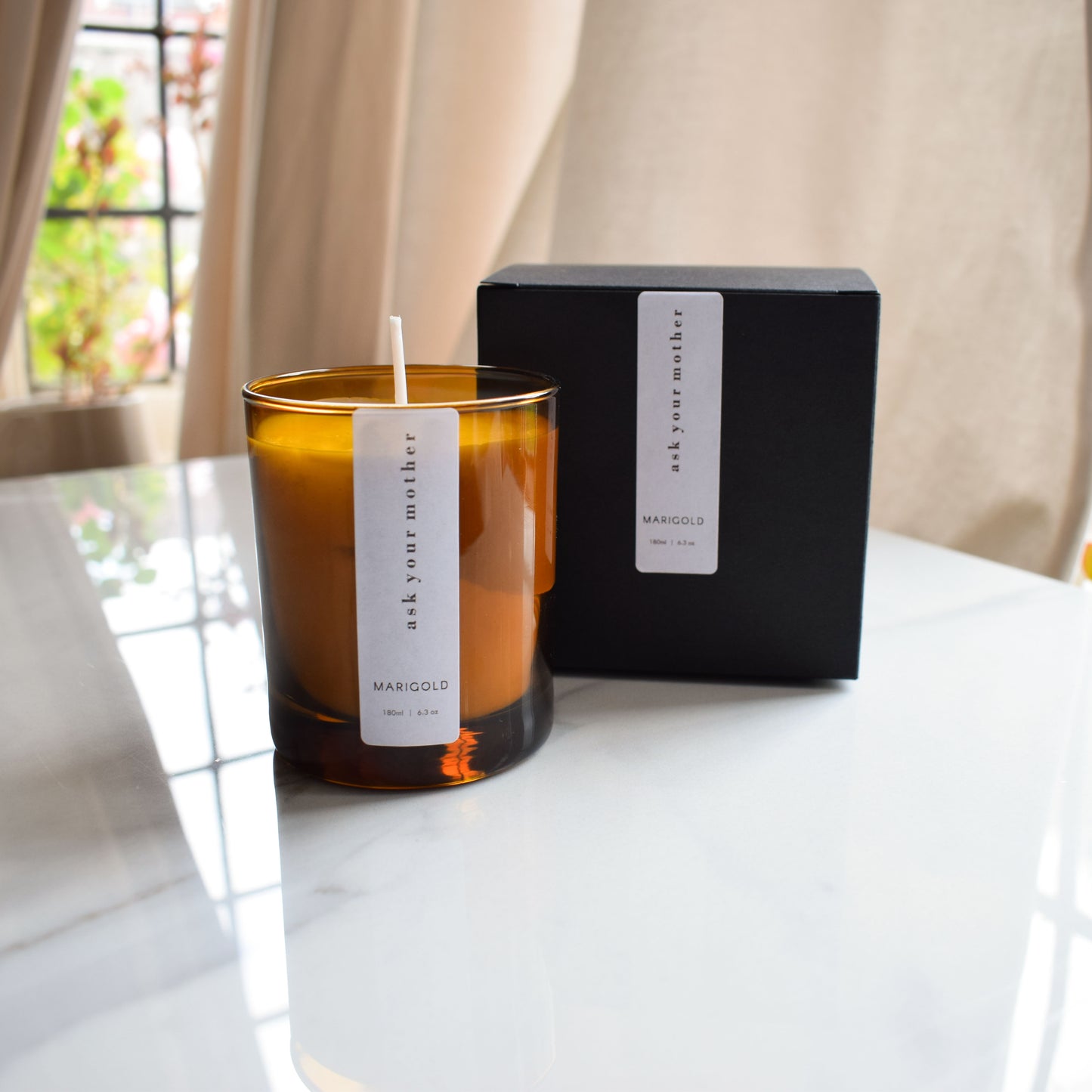 Ask Your Mother Scented Sandalwood and Bergamot Eco Soy Wax Candle by window