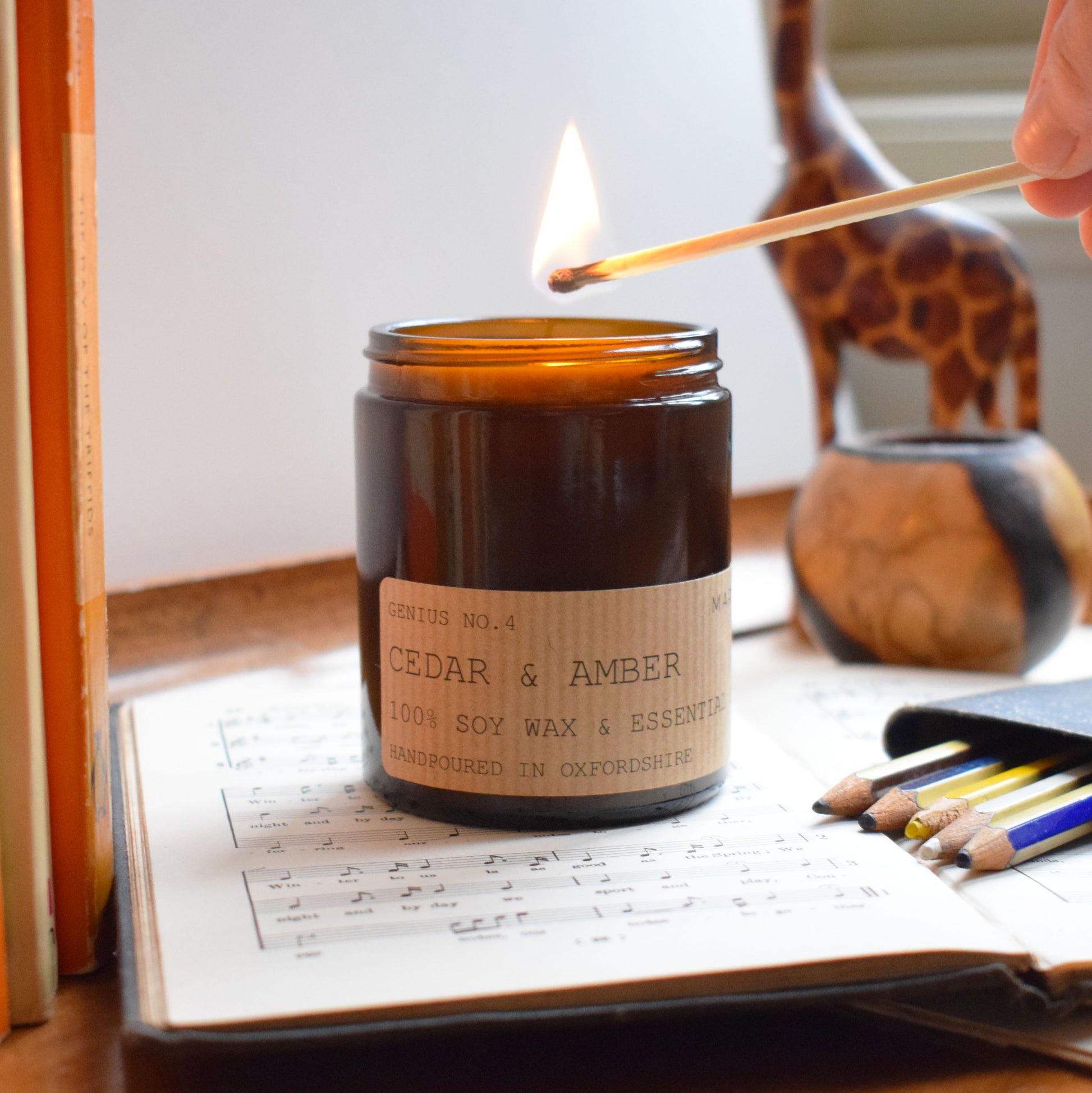 Cedar & Amber Eco Soy wax candle being lit
