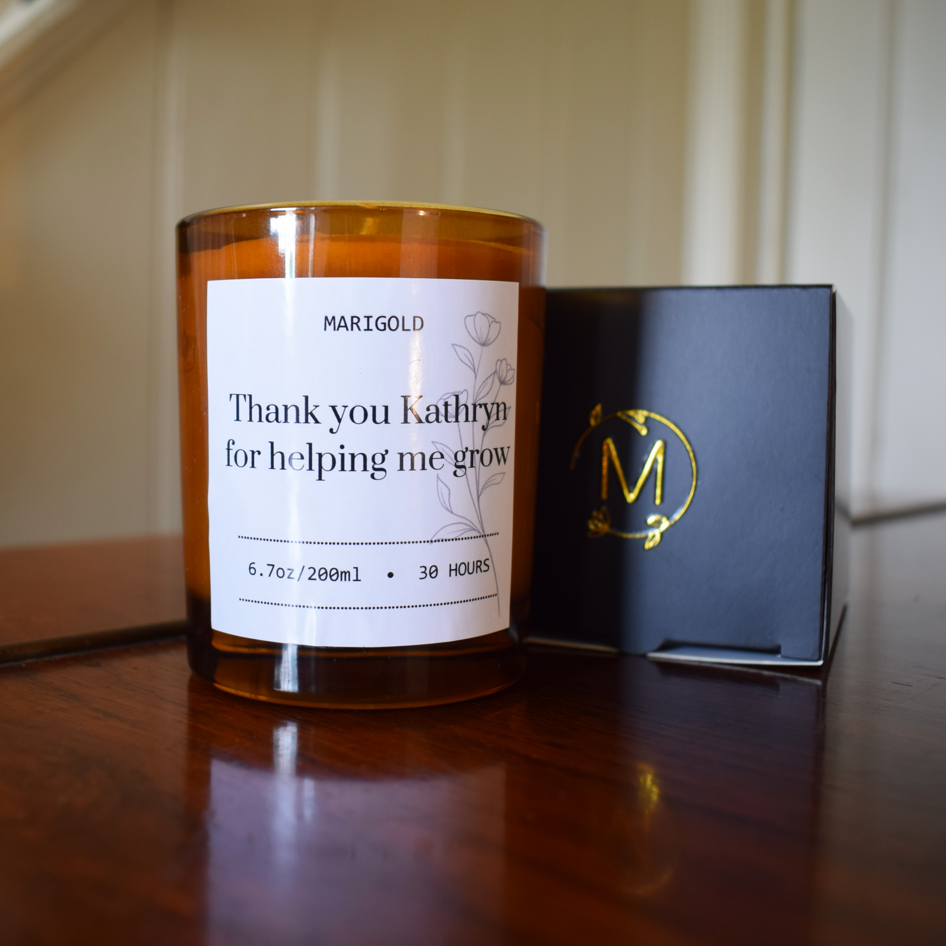 Thank you Teacher Candle and its packaging with a personalised message on a wooden surface.