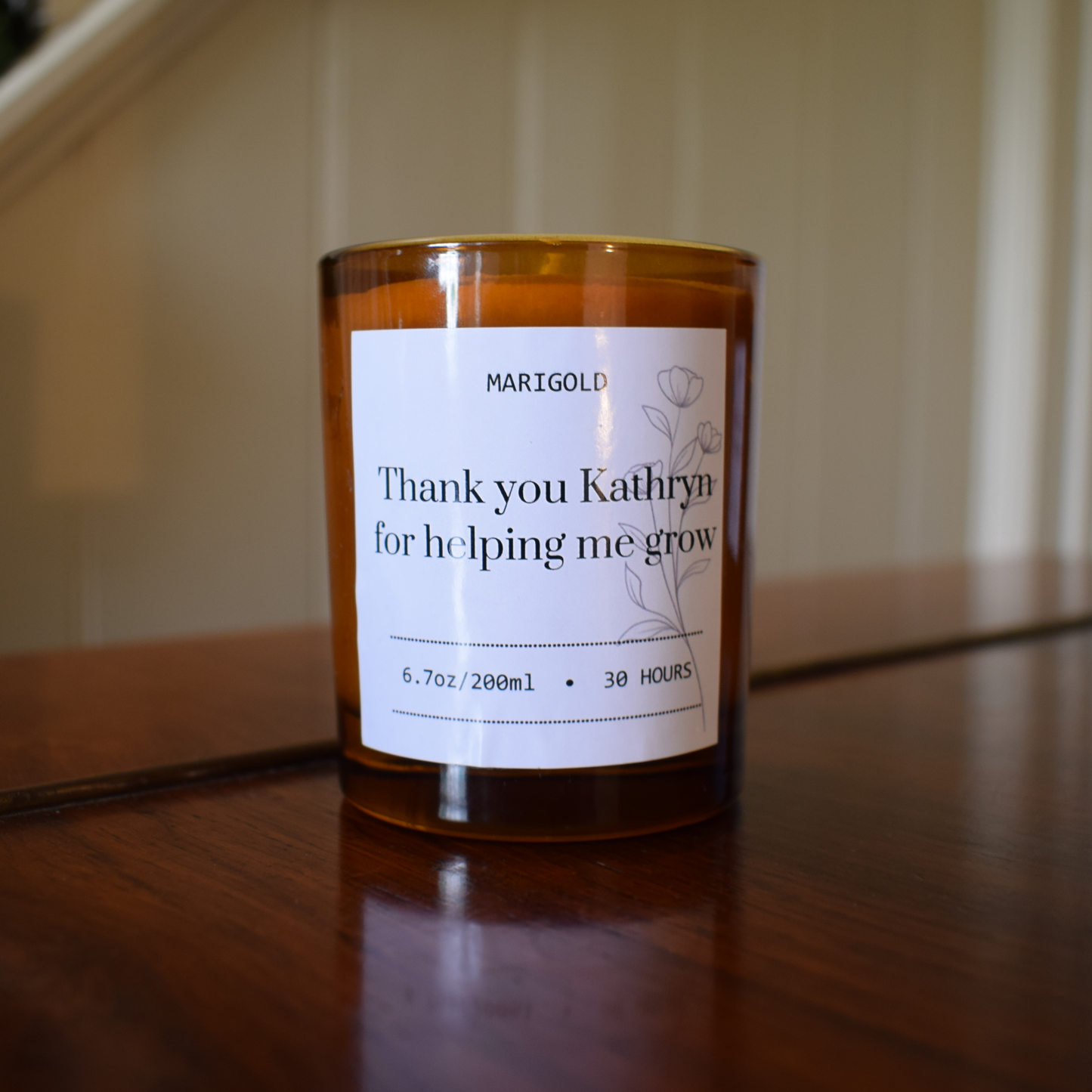 Thank you Teacher Candle with a personalised message on a wooden surface.