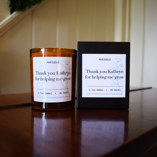 Thank you Teacher Candle and its packaging with a personalized message on a wooden surface.