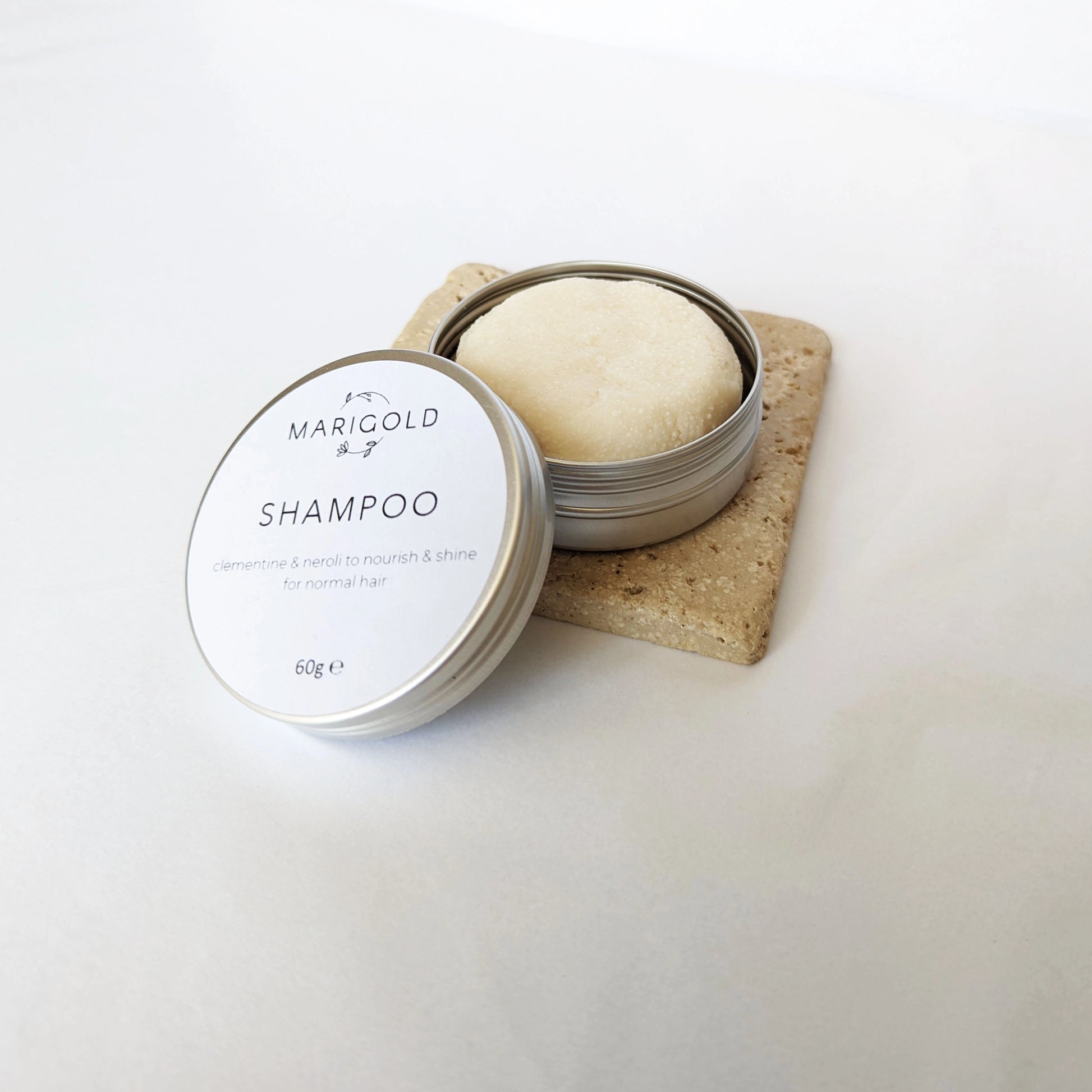 'Citrus Burst' Solid Shampoo Bar open tin on tile