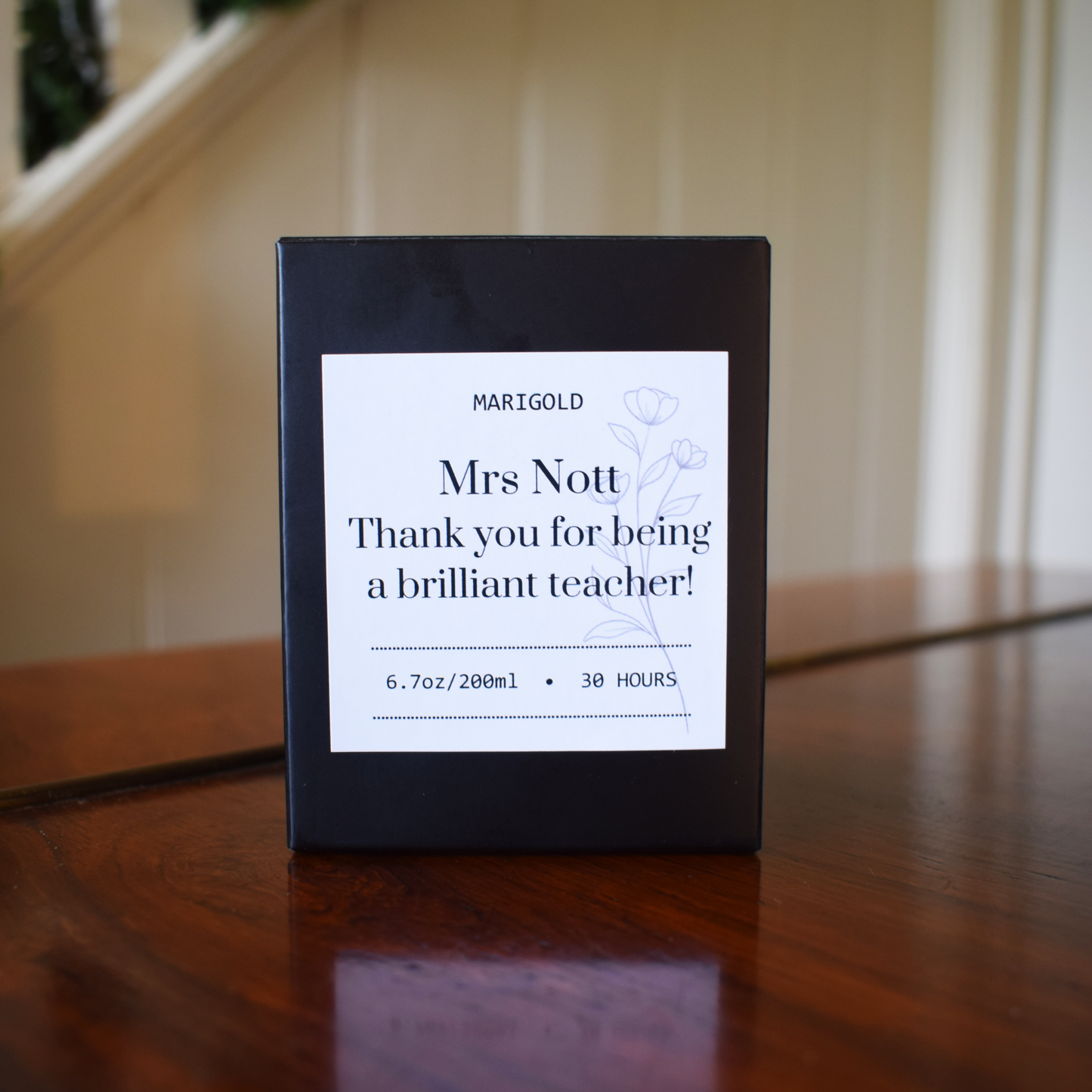 Thank you Teacher  Candle Black box with a white label on a wooden surface