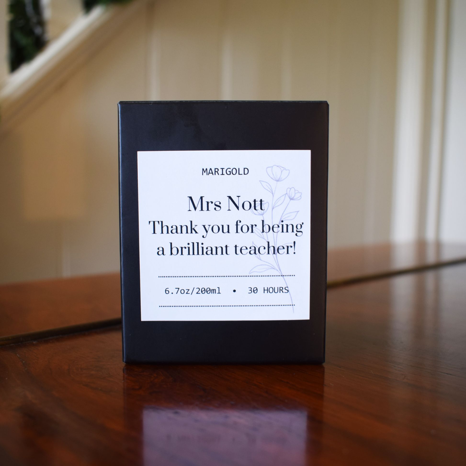 Thank you Teacher  Candle Black box with a white label on a wooden surface