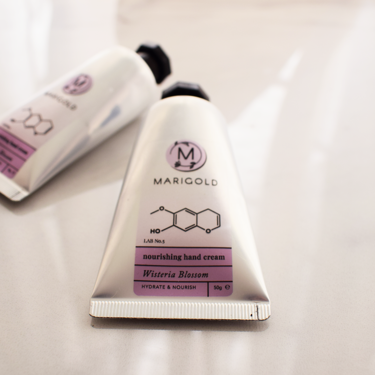 Marigold nourishing wisteria hand cream with a visible brand logo on a light background