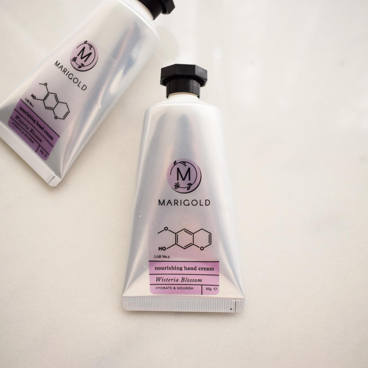 Marigold Wisteria hand cream on a light background