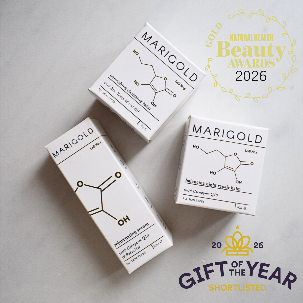 Three MARIGOLD skincare product boxes arranged on a light gray surface, with a gold 'Beauty Awards 2026' badge and a 'Gift of the Year Shortlisted' graphic in the background.